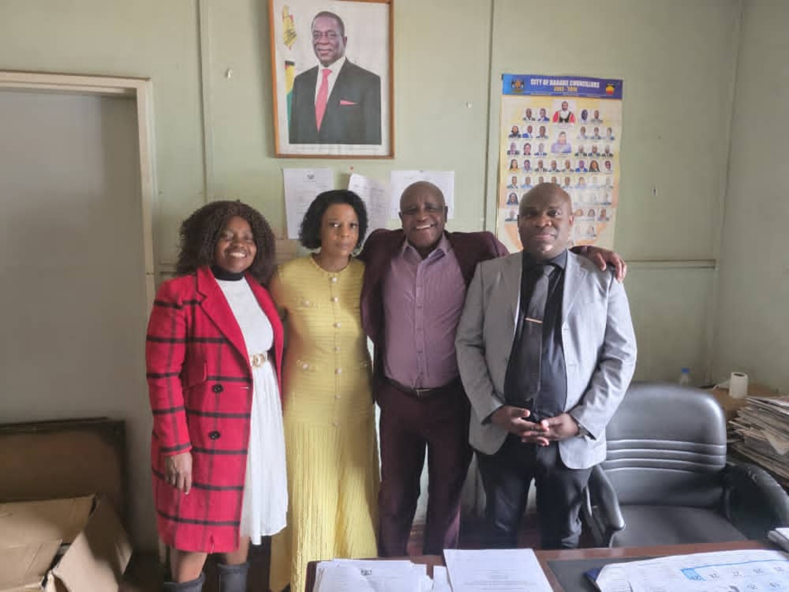 A group of four people pictured in an office