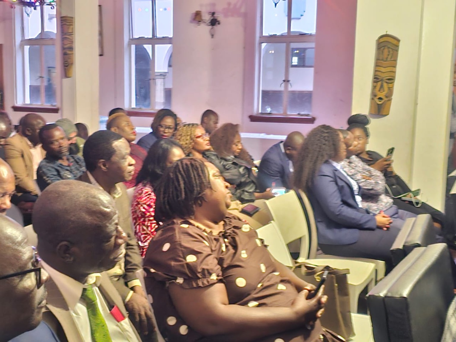 People seated in rows during a gathering